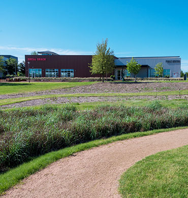 A landscaped pathway leading to retail shopping